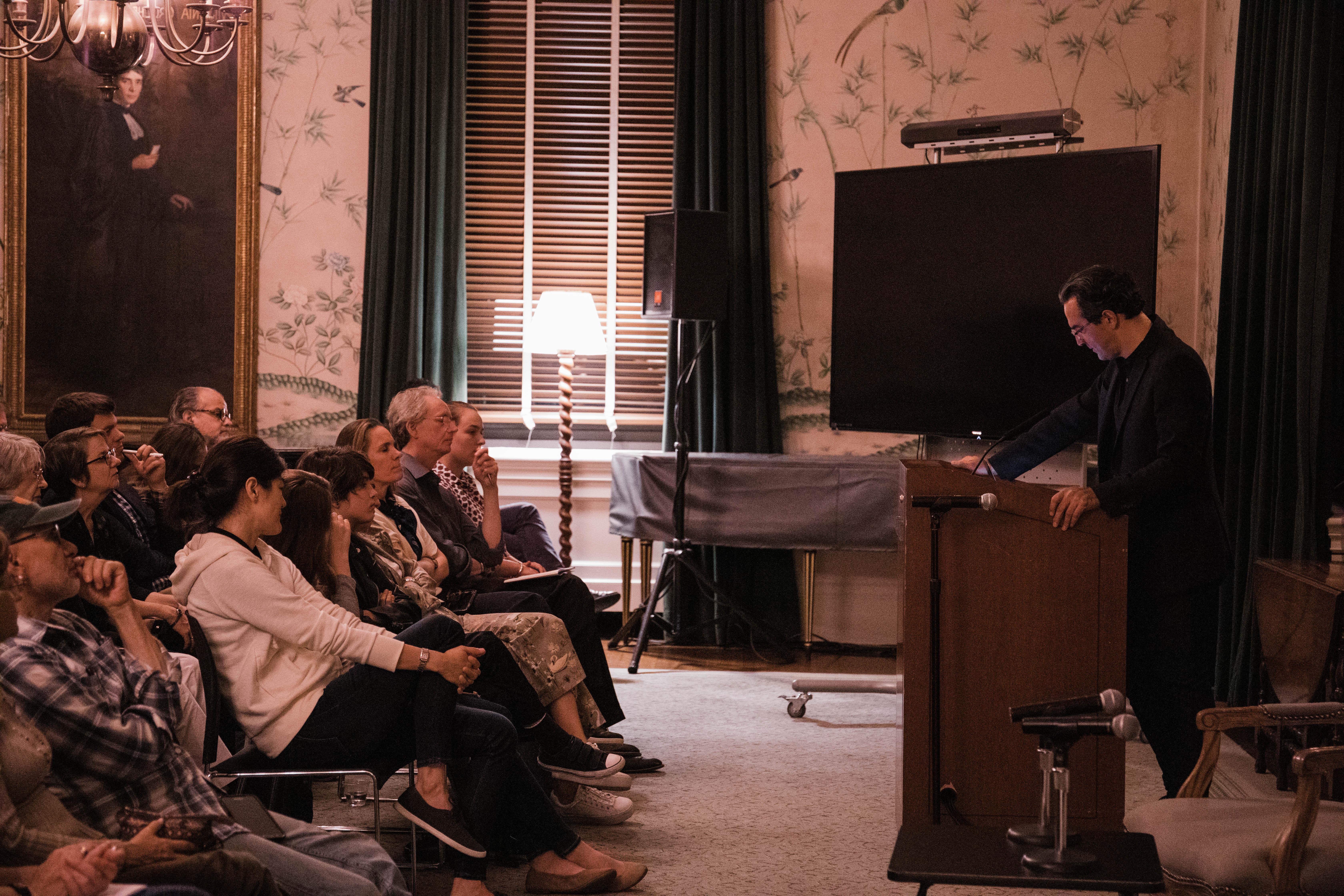 At lectern and audience